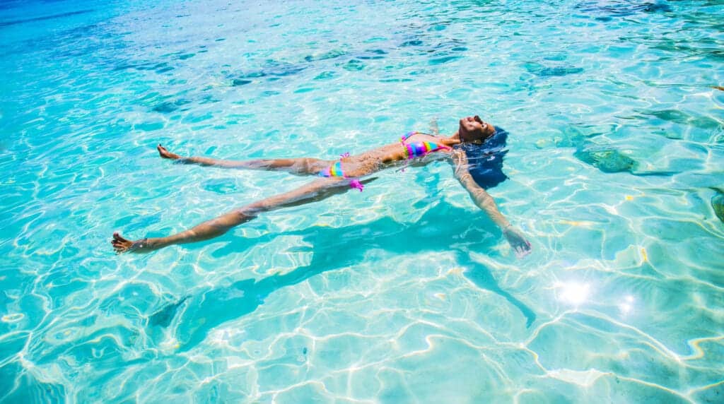 Woman swimming in the pool during the summer time. Staying in the pool for too long is not good for vaginal health and can contribute to vaginal infections like bacterial vaginosis, yeast infections, and urinary tract infections. 