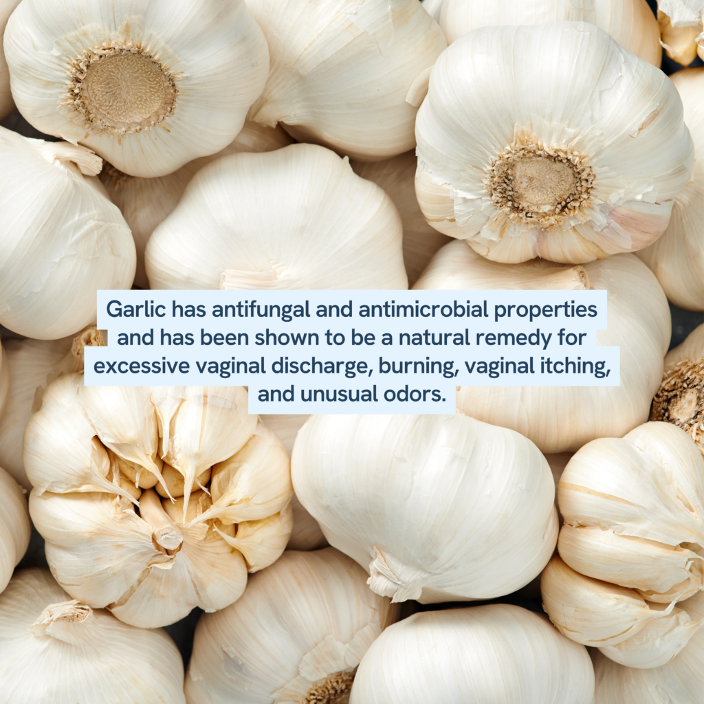 cluster of garlic bulbs and highlights garlic's health benefits. Garlic is noted for its antifungal and antimicrobial properties, making it a natural choice for addressing symptoms like excessive vaginal discharge, burning, itching, and unusual odors. It's a natural remedy that has been used for its health-supporting qualities in various cultures.
